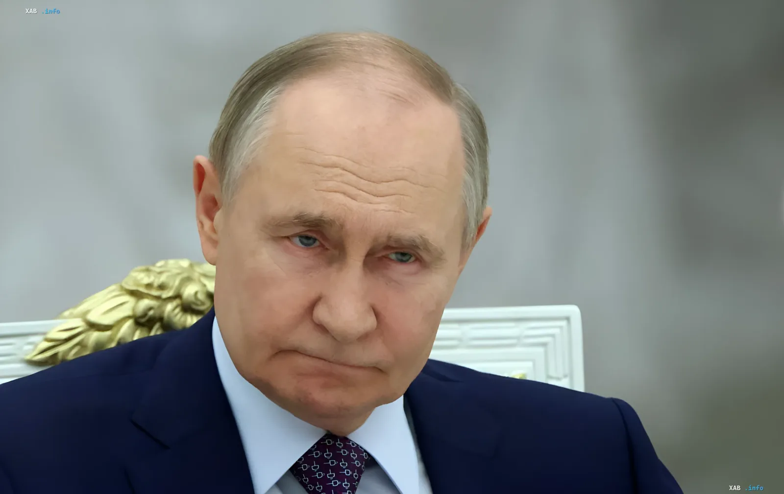 Vladimir Putin against the backdrop of a carved Kremlin chair — at the centre of Moscow's rhetoric that EU Commissioner Kubilius criticized