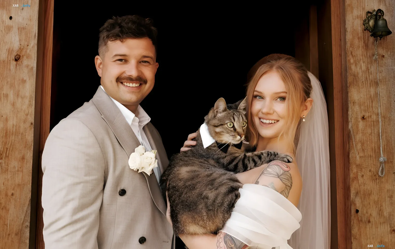 Roman Shcherban and Anastasiia Lisohub at their wedding photoshoot with a dressed cat