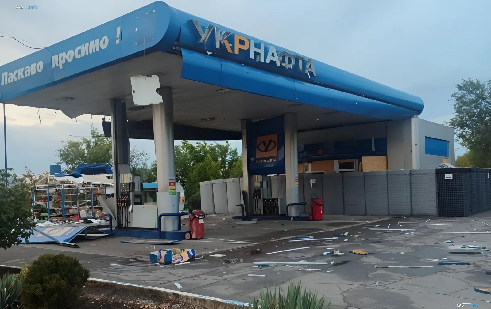 Damaged Ukrnafta gas station after a Russian strike: canopy debris and broken panels scattered across the forecourt