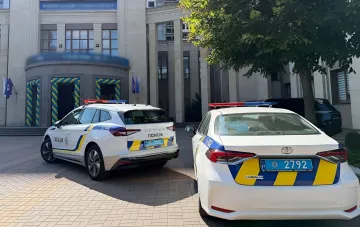 Ukrainian police patrol cars parked outside a Kyiv university building where a first-year student initiation ceremony was held with sirens