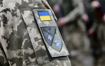 Armed Forces of Ukraine patch on a soldier's camouflage uniform
