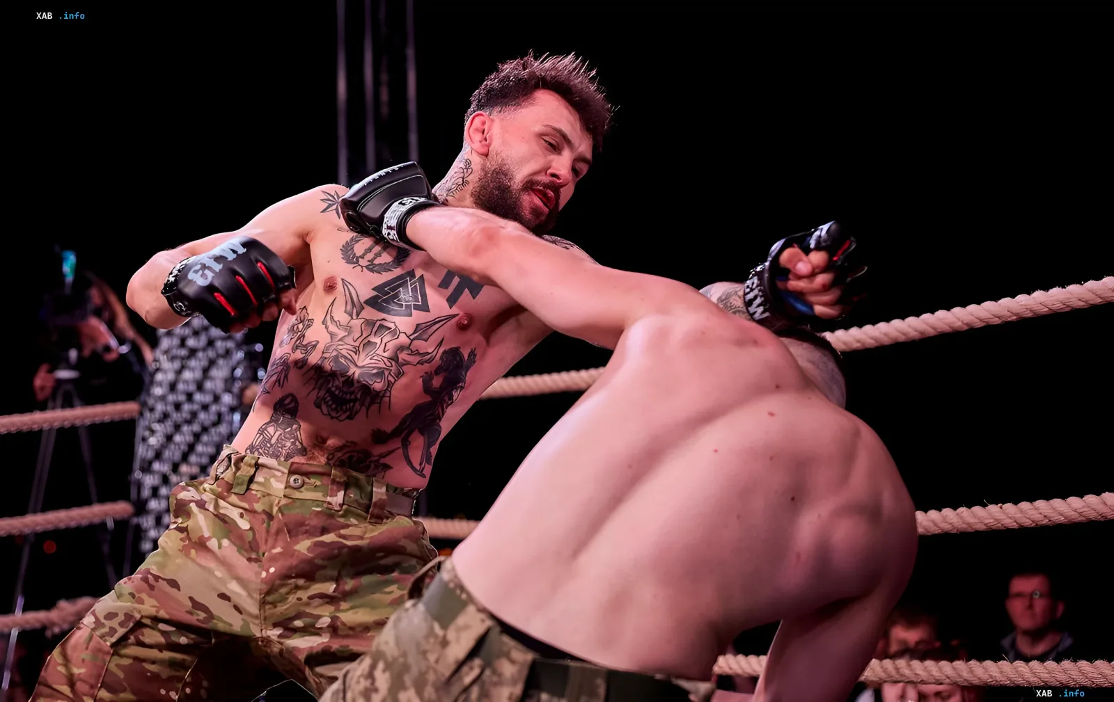 Fighters of the M13 veterans movement in gloves with the organization's logo during a match in the ring