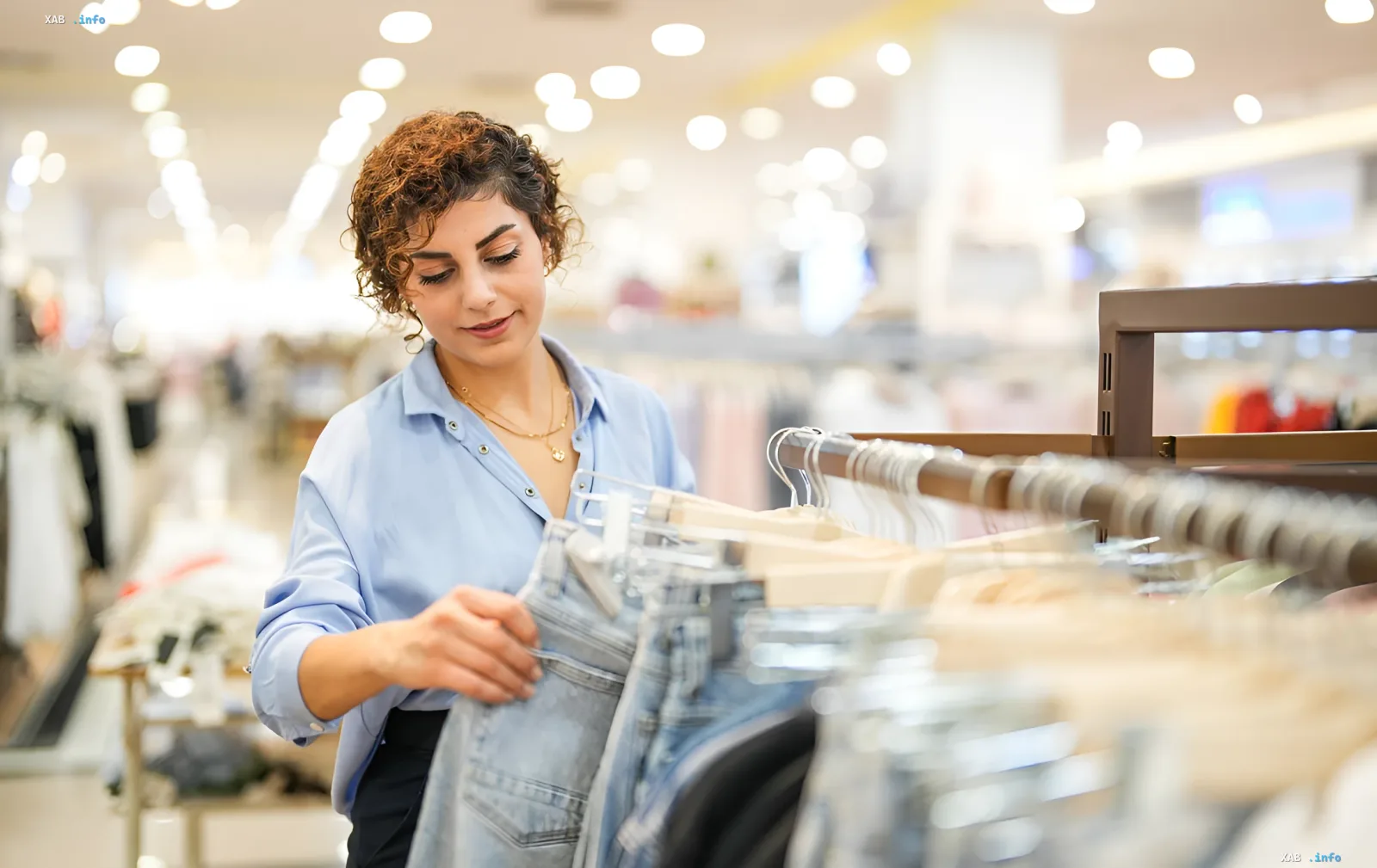 A shopper browsing jeans in a Kyiv shopping mall that continues operating under new yellow alert rules