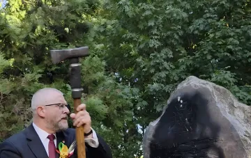 Euro MP Braun with an axe next to a destroyed UPA monument in Poland