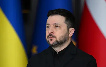 Volodymyr Zelensky against the backdrop of Ukrainian and EU flags, ready for a personal meeting with Putin at the G20 summit in Miami