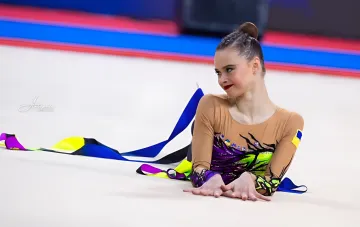 Gymnast Onofriychuk with clubs after her routine in Brno — third all-around gold of the season
