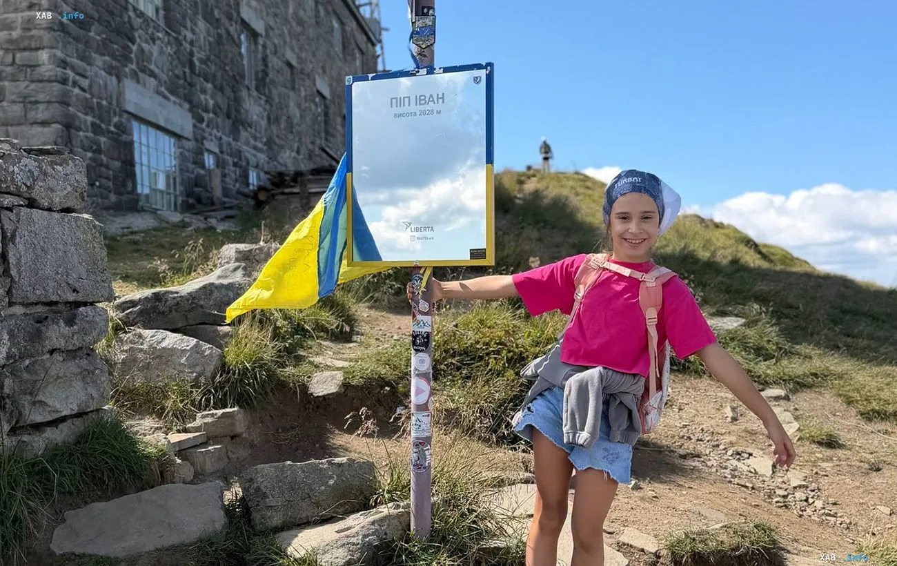 Nine-year-old Evelina Sarkisyan at the summit of Pip Ivan (2028 m) with the Ukrainian flag after conquering all six 2000m peaks of the Carpathians