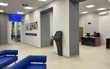 Interior of the Pechersk district CNAP (public service center) in Kyiv: waiting area, self-service terminal and service window under air-raid alert operating modes