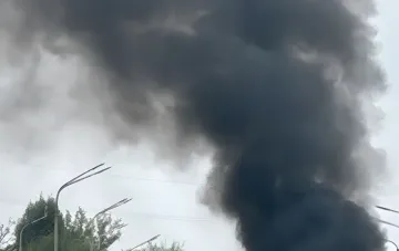 Thick black smoke rising over Pavlograd after the strike on a transport artery