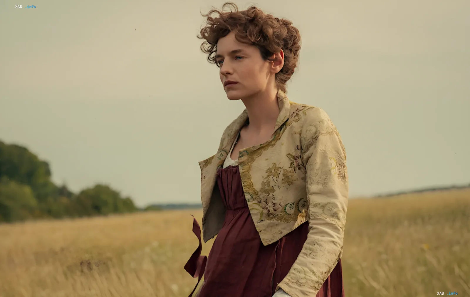 Emma Corrin in the first look from Netflix's new Pride and Prejudice, wearing period costume in a golden field