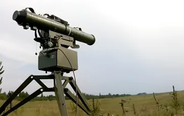Stugna-P anti-tank missile system on a tripod mount angled upward to intercept a drone in a Ukrainian field