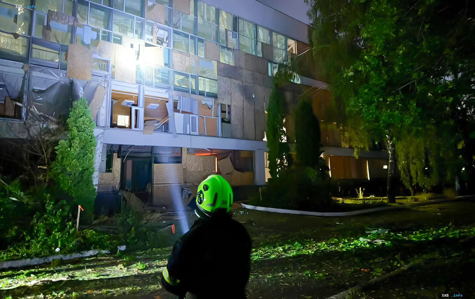 Rocket-damaged Shevchenko University sports complex in Kyiv at night: firefighter works on the aftermath of the attack