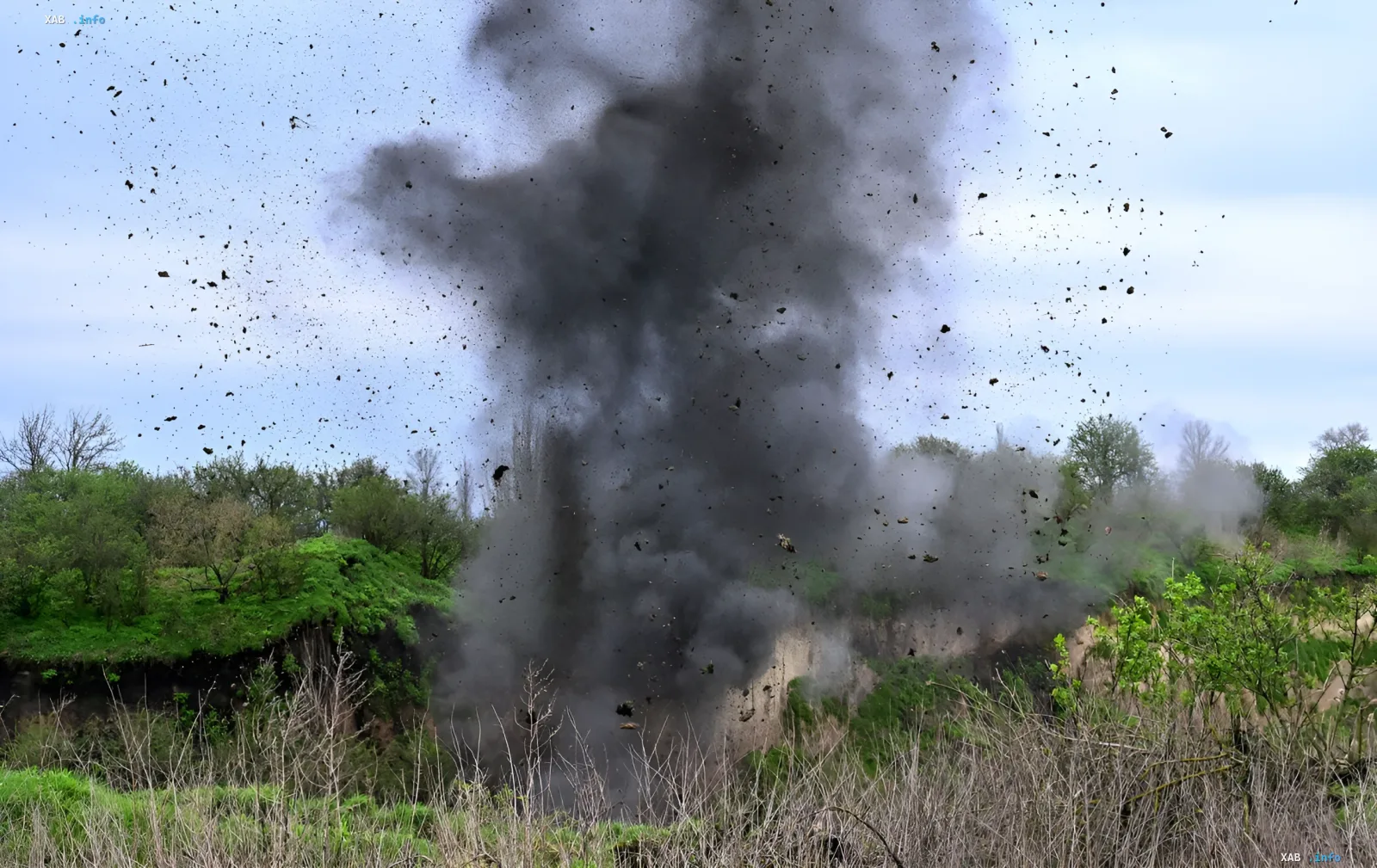 Massive plume of smoke and flying debris after a mass explosion at a granite quarry in Rivne Oblast