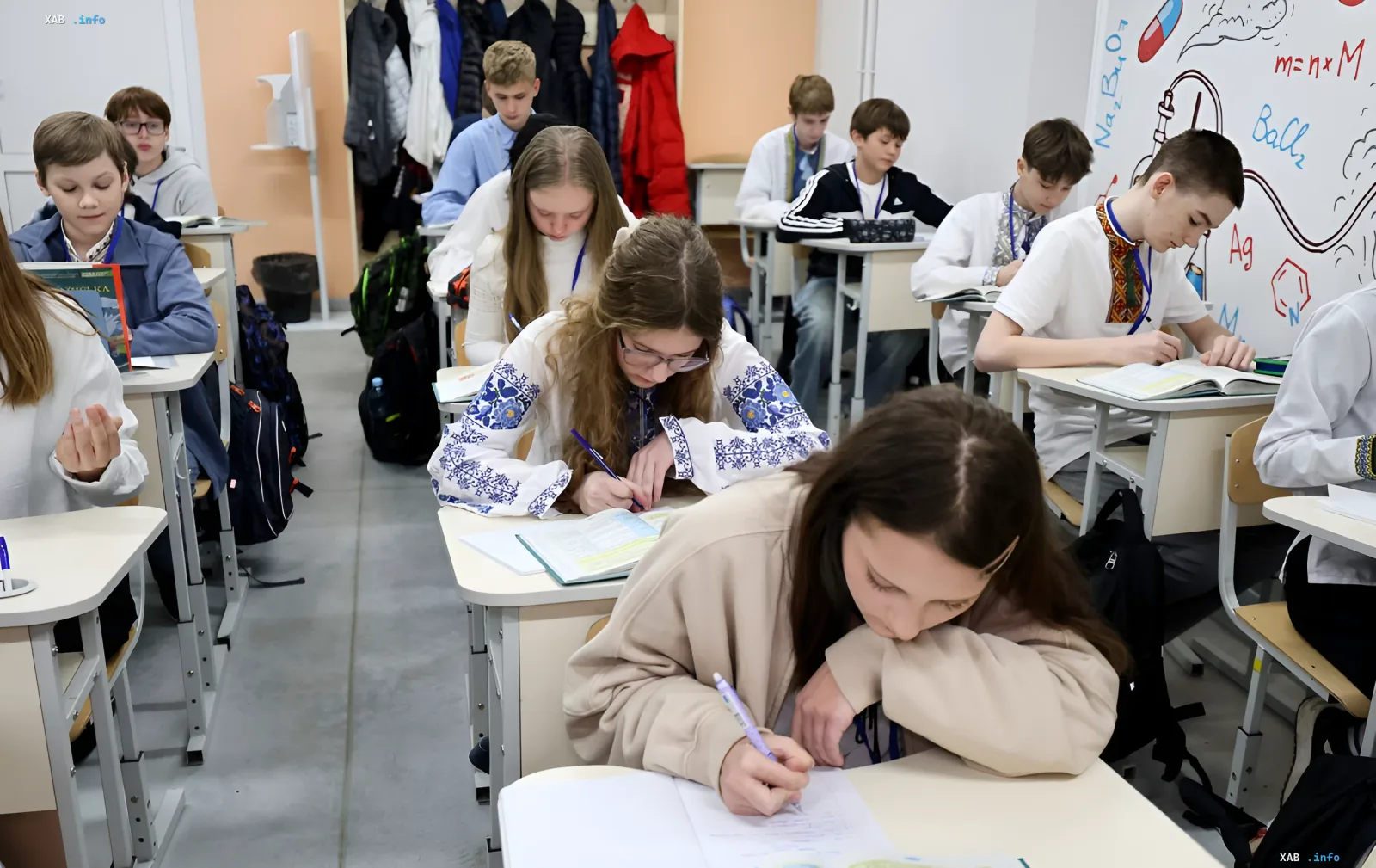 Ninth-grade students at their desks in a Ukrainian school during a lesson with textbooks and notebooks