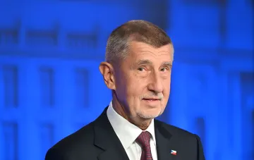 Czech Prime Minister Andrej Babis against a blue backdrop, discussing the initiative to create the European air defense system Euro Patriot