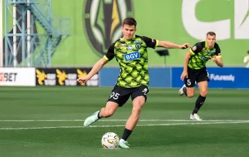 Polesia player wearing number 95 controlling the ball during the UPL match against Kryvbas