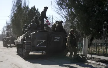 Russian soldiers on an armored vehicle marked with the letter Z, in context of the ISW report on the Kremlin exaggerating front-line gains