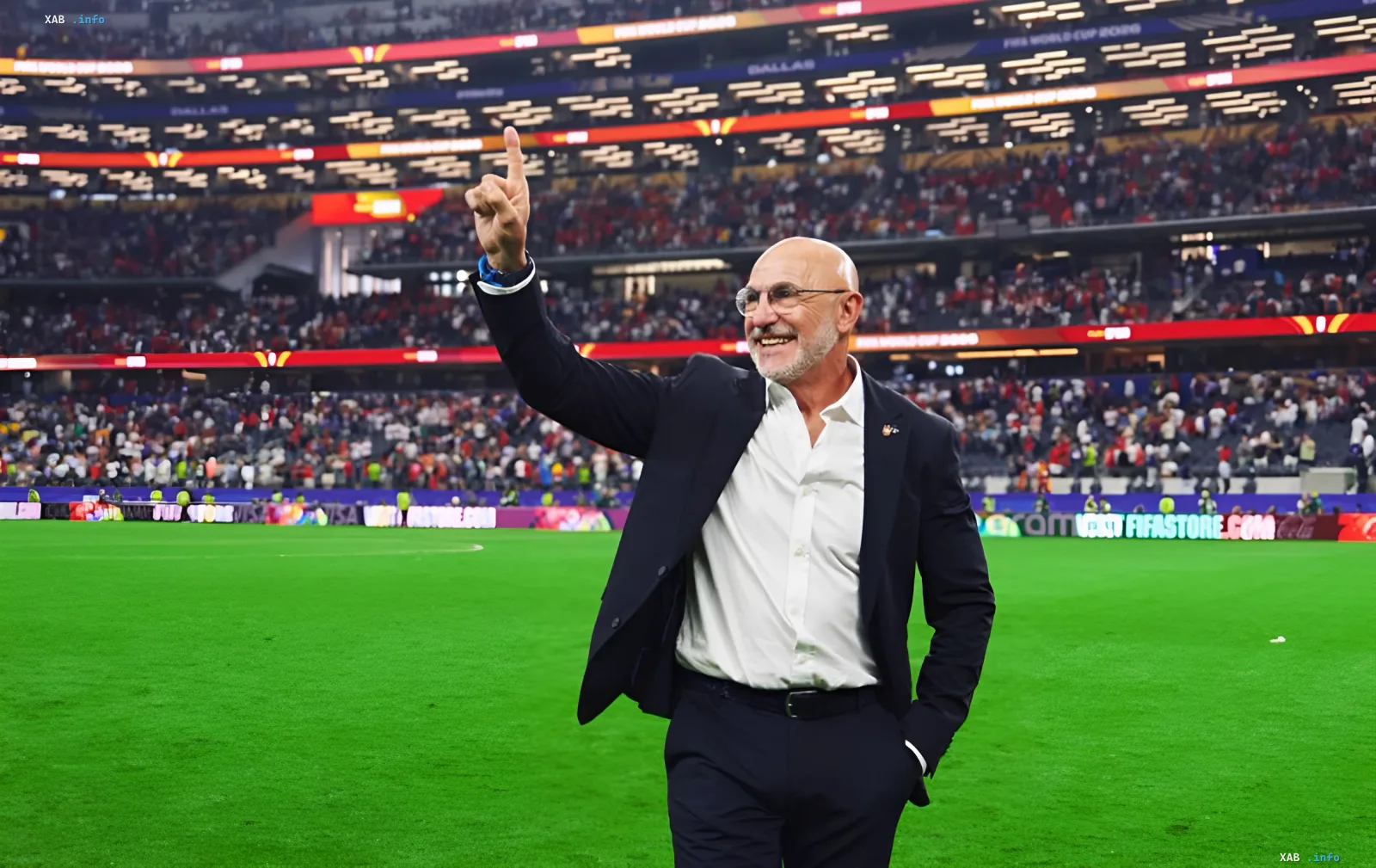Spain head coach De la Fuente on the stadium pitch after the 2026 World Cup, pointing upward