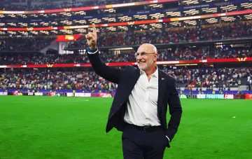 Spain head coach De la Fuente on the stadium pitch after the 2026 World Cup, pointing upward