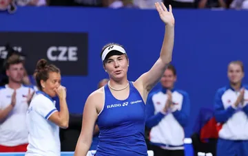 Czech tennis player in blue RADO kit waves to the crowd after winning a Billie Jean King Cup match in Shenzhen