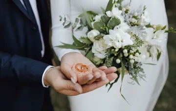 Wedding rings in the hands of a bride and groom — a symbol of online marriage via the Diia app for widows and widowers