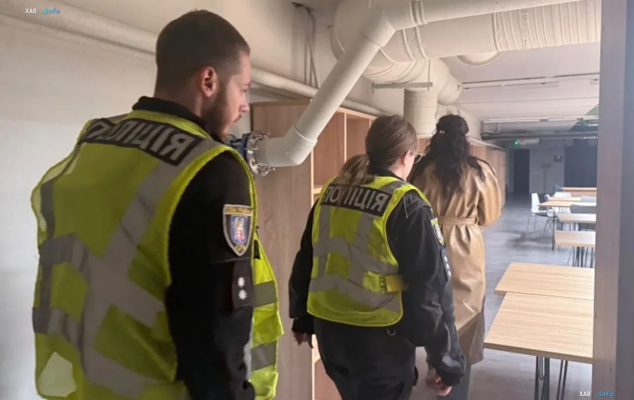 Ukrainian police officers inspect a university building in Kyiv following an incident where students were allegedly denied access to a shelter