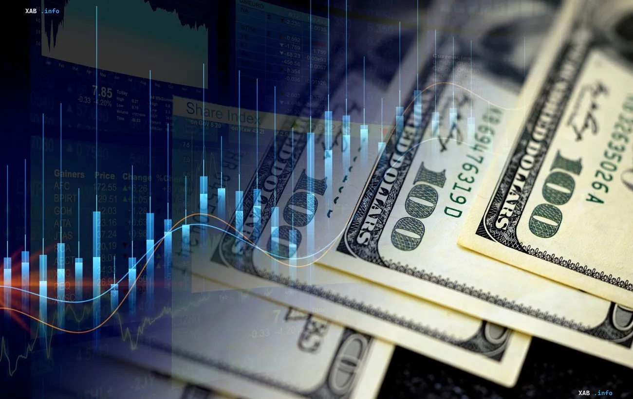 US dollar bills over a stock market chart: NBU dollar rate rises to 44.78 UAH on September 23