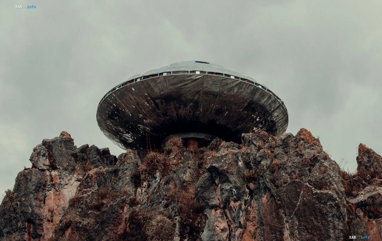 Disc-shaped UFO hovering over a rocky cliff — illustration of the Pentagon's declassified documents on anomalous objects