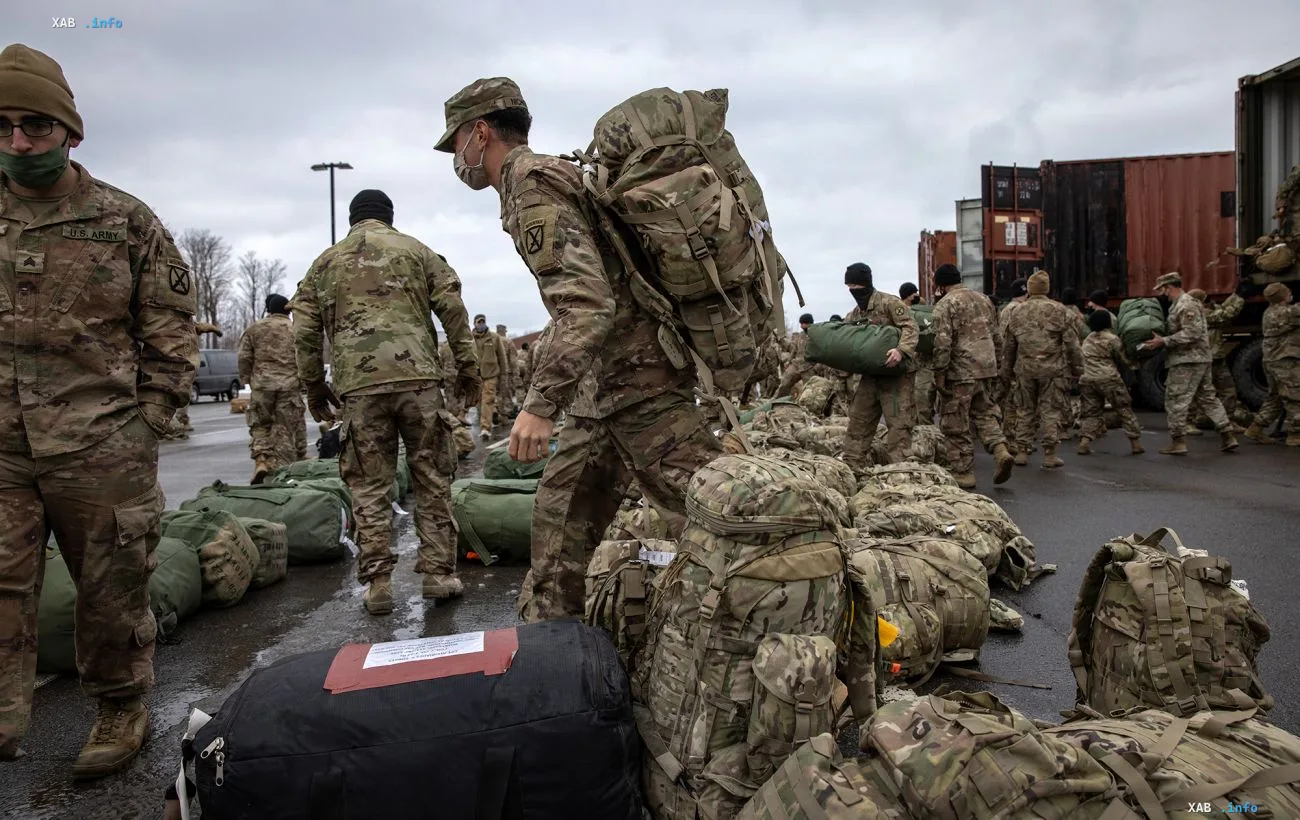 US Army soldiers with rucksacks and gear near trucks and shipping containers as part of renewed military presence in Greenland