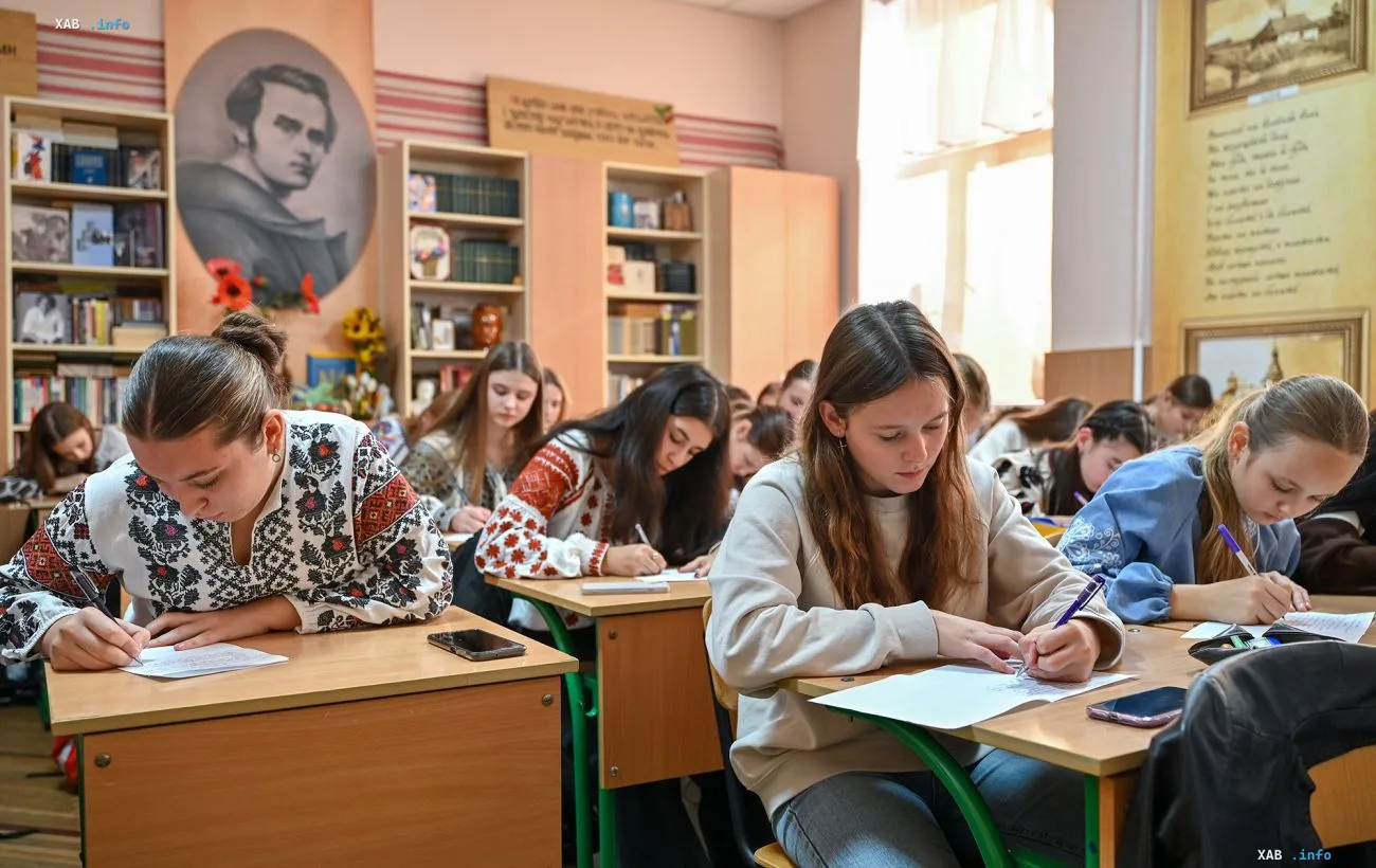 Female students writing at their desks during a lesson in a Ukrainian school classroom, illustrating the news about flexible class schedules of up to 35 minutes approved by Ukraine's Ministry of Education