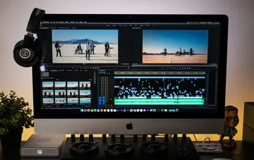 Professional video editing interface of Adobe Premiere Pro with a timeline and video preview on a workstation
