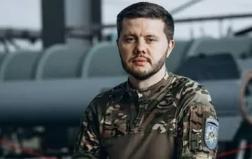 Ukrainian Armed Forces Major Oleksiy Reva in camouflage uniform in front of military equipment