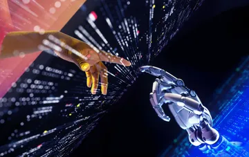 A human hand and the robotic hand of Anthropic's Claude Opus 5.5 nearly touch fingers against a backdrop of data streams — a symbol of strict safety controls and human-AI collaboration