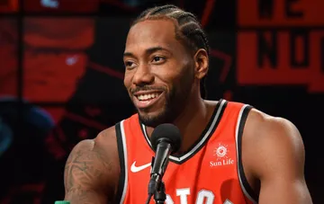 Kawhi Leonard in a Toronto Raptors jersey at a press conference after signing a two-year contract extension
