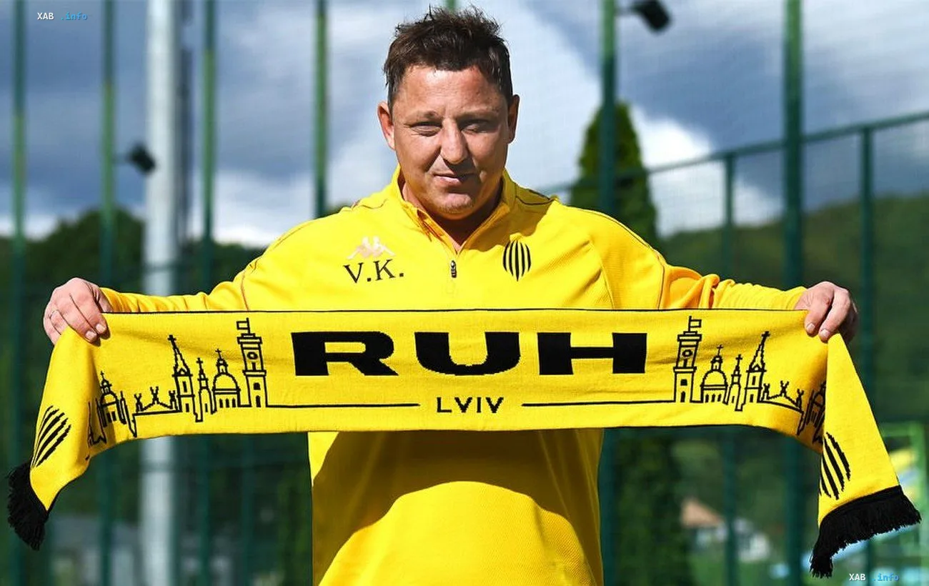 Vasyl Kobyin in Rukh kit holding a club scarf at the Lviv academy training ground