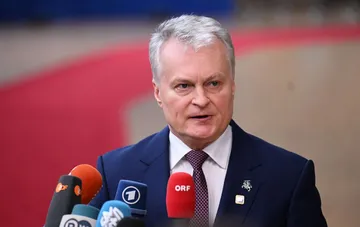 President of Lithuania at a press conference with international media microphones, commenting on the war and Russia's position at the UN podium