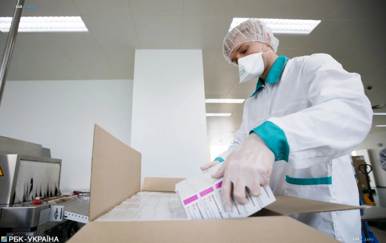 A worker at the Darnitsa pharmaceutical plant in Kyiv packs boxes of medicines on the production line