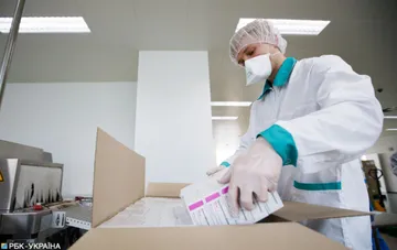 A worker at the Darnitsa pharmaceutical plant in Kyiv packs boxes of medicines on the production line