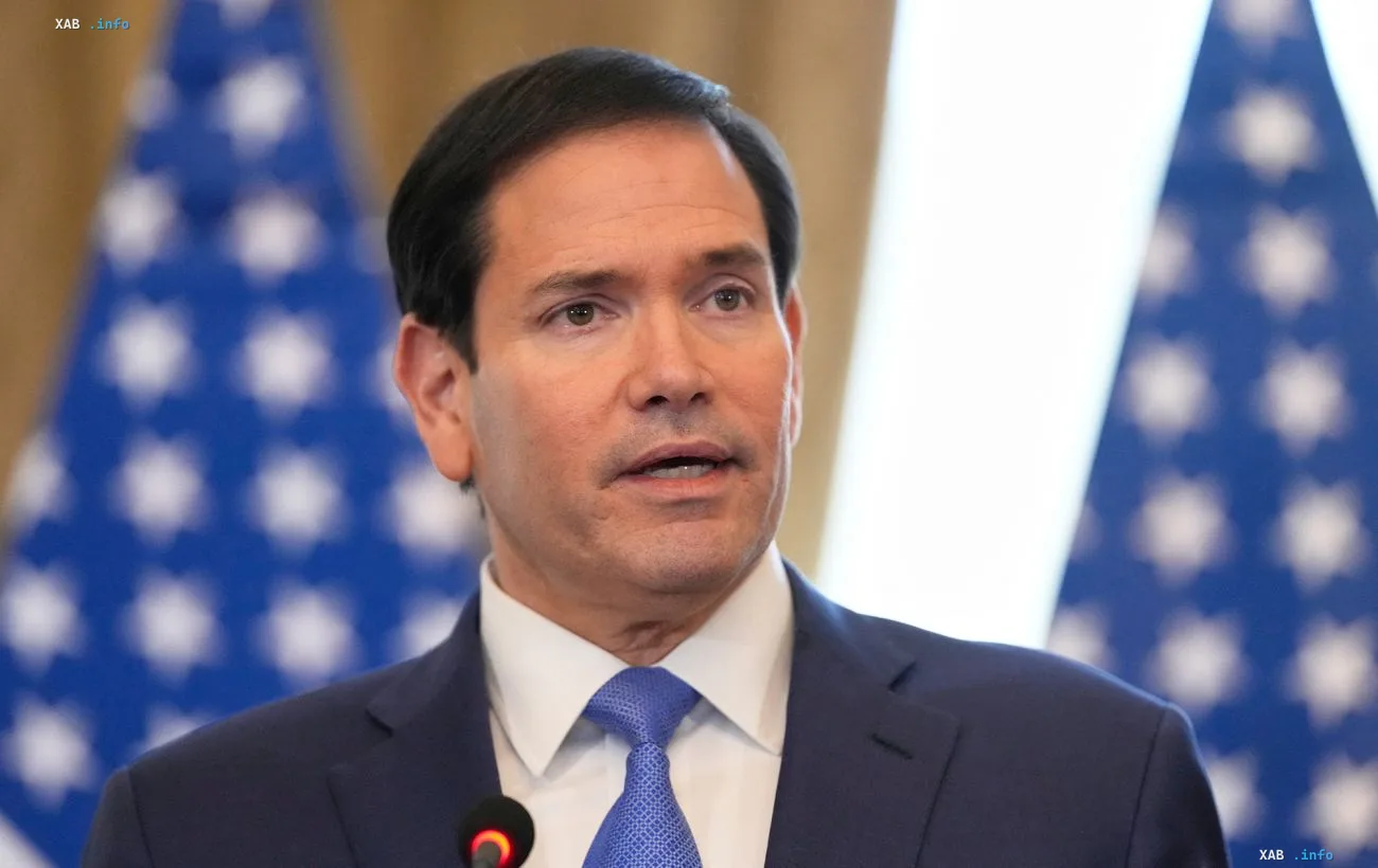 Marco Rubio at a press conference in front of American flags, commenting on negotiations to end Russia's war against Ukraine