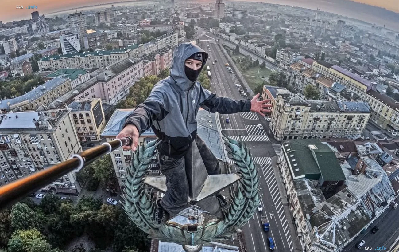 Roofer with a selfie stick on the star of Kharkiv's 'House with a Spire' at sunrise