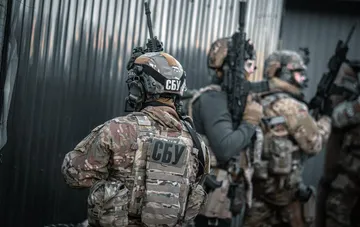 SBU special forces operatives in camouflage with rifles after thwarting a terror plot in central Rivne