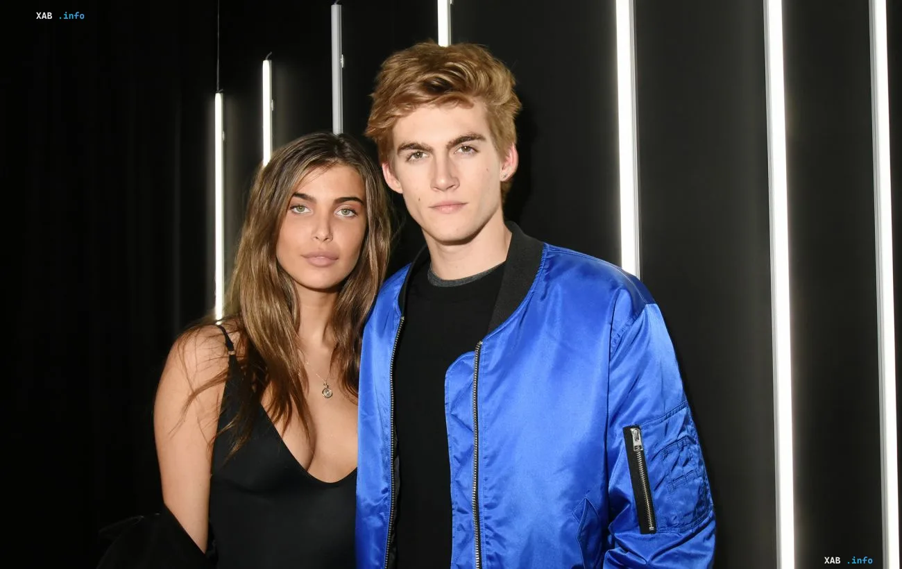 Presley Gerber and his ex-girlfriend posing against a backdrop of glowing vertical lines in an archival photo