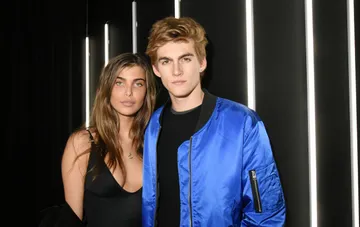 Presley Gerber and his ex-girlfriend posing against a backdrop of glowing vertical lines in an archival photo