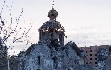 Destroyed Church of John the Baptist in Kramatorsk after a Russian air bomb strike, damaged dome and apartment buildings in the background