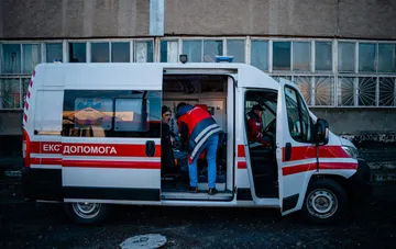 Emergency medical workers of a Kyiv ambulance treating a patient during air raids and at strike sites