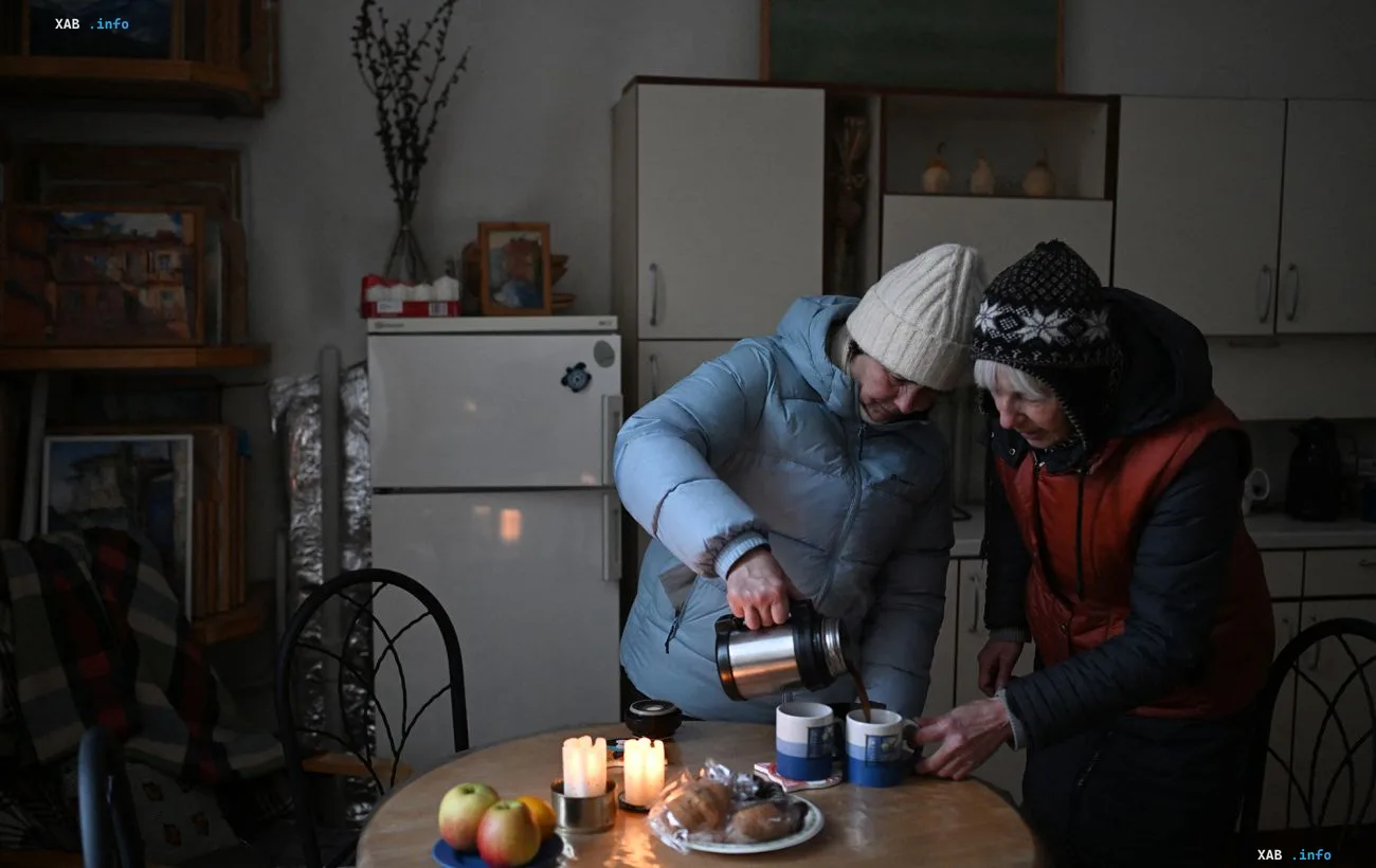 Residents of Teremky in winter clothes warming up with hot tea in a cold, unheated apartment