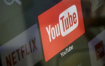 YouTube logo on a device screen highlighting the launch of Gemini-powered personalized feeds
