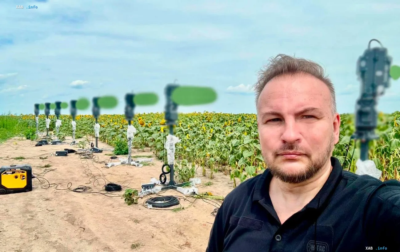 Field deployment of telecom equipment in Ukraine: a line of communication relays against a sunflower field