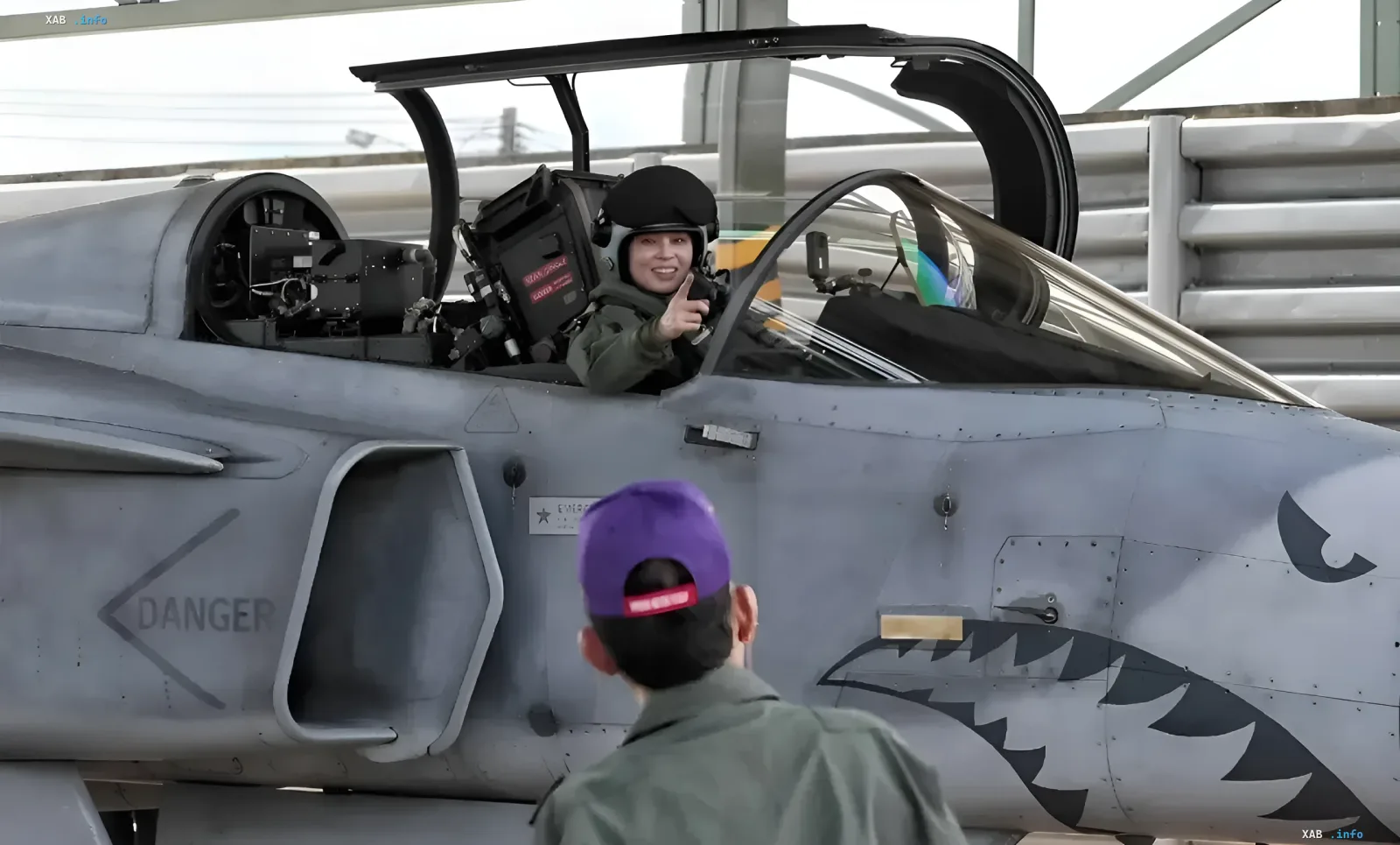 Queen Suthida of Thailand next to a Gripen fighter jet