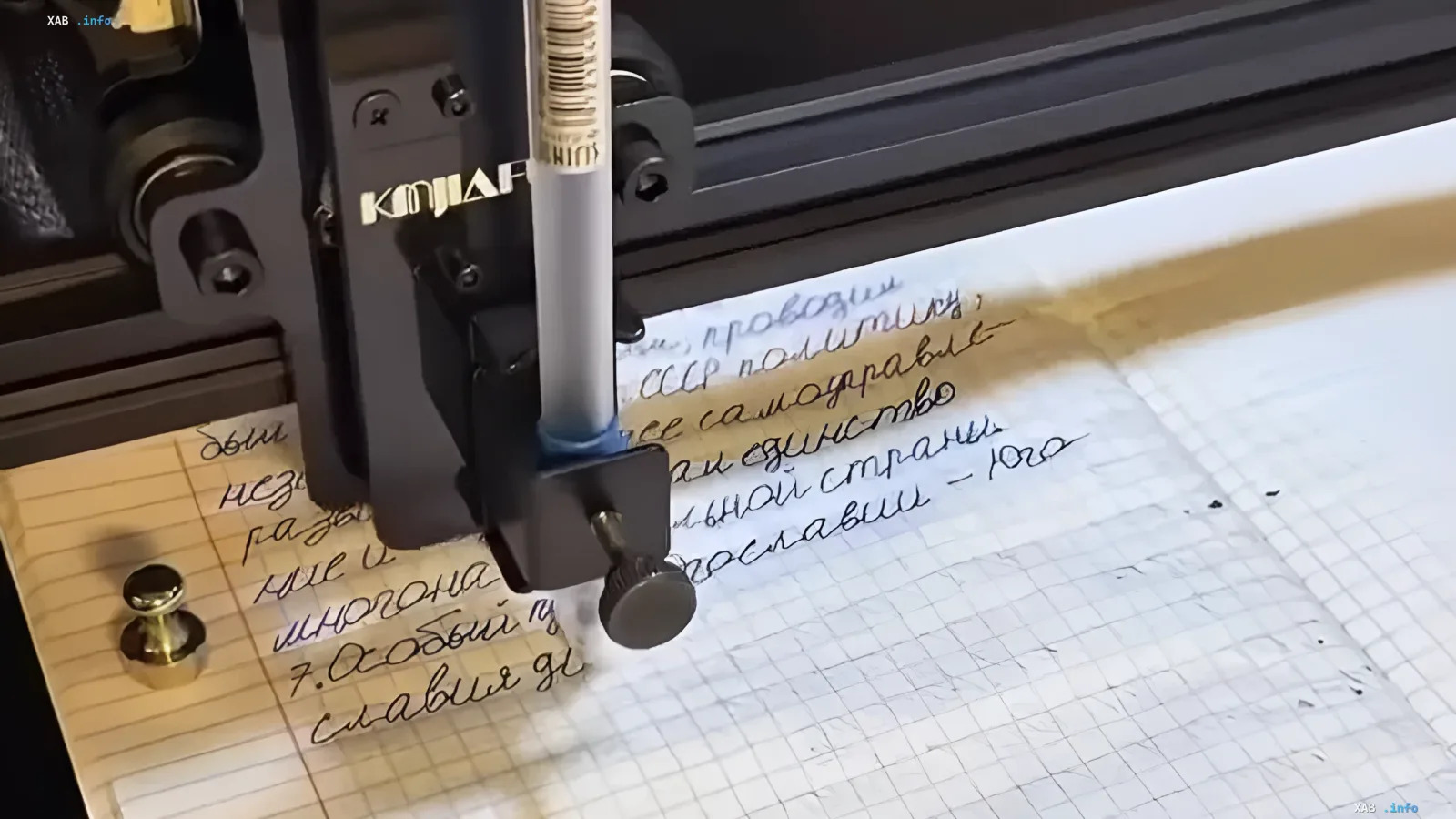 Robot holding a pen and writing in a notebook